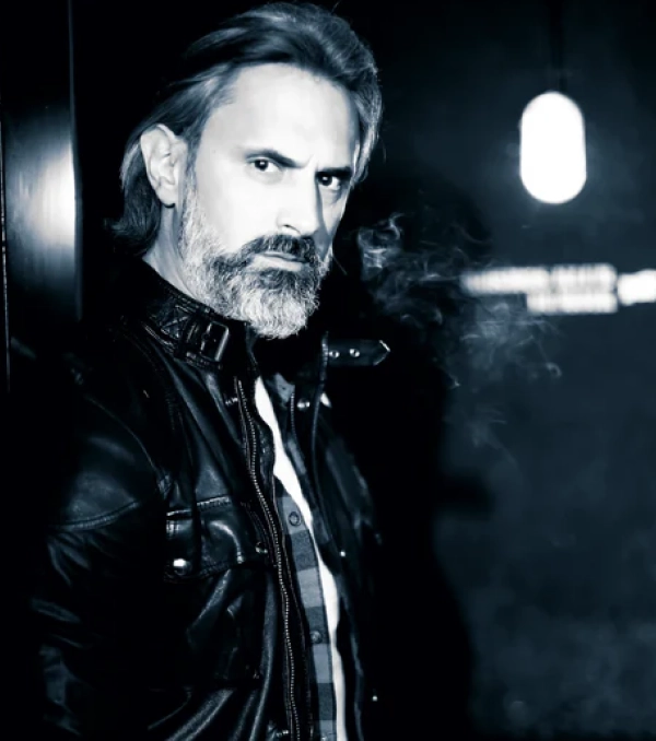 Man with a stylish beard, demonstrating a beard care tip for smooth, less brittle beard hair using Beard Treatment cream.