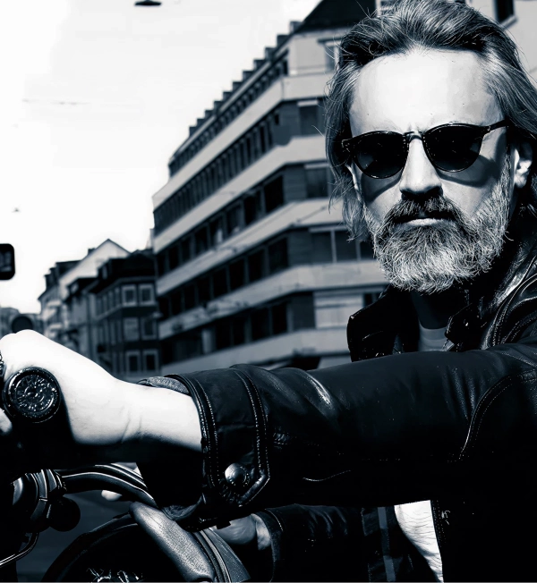Man with a well-groomed beard and stylish hair, demonstrating beard care and hairstyling using nourishing beard oil, scrub, and balm.